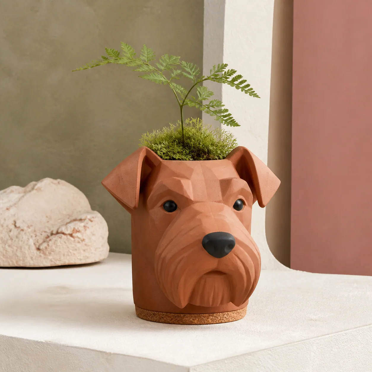 Concept imagery: pet-head planter object with a small moss plant